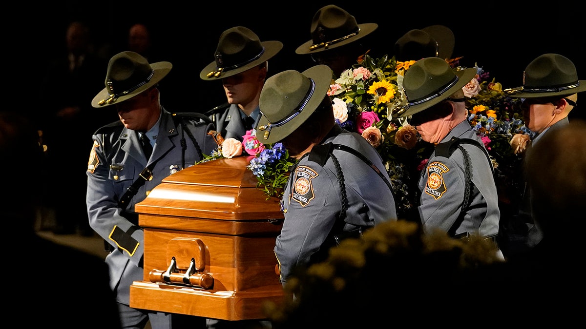 Rosalynn Carter casket positioned by police officers