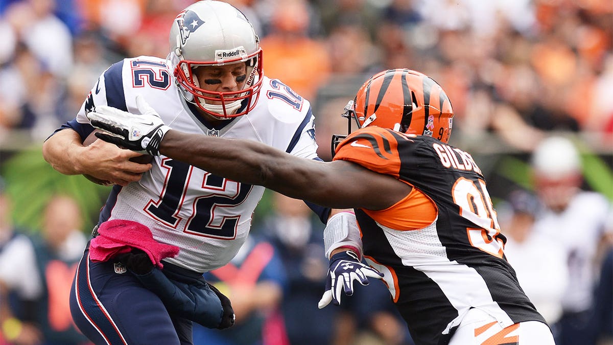 Wallace Gilberry, right, tackling Tom Brady