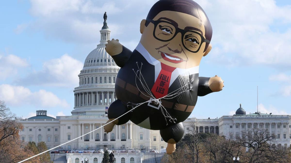 a giant balloon depicting Congressman George Santos flying outside the U.S .Capitol building