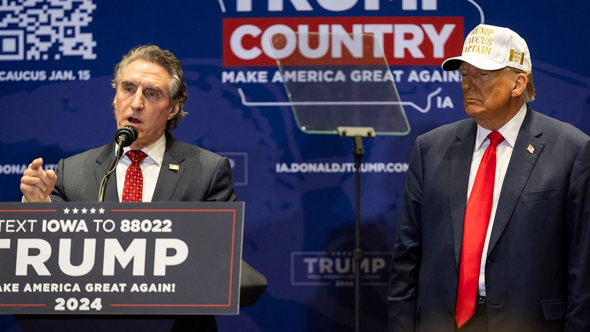 Doug Burgum, left, endorsing Donald Trump, right, at rally