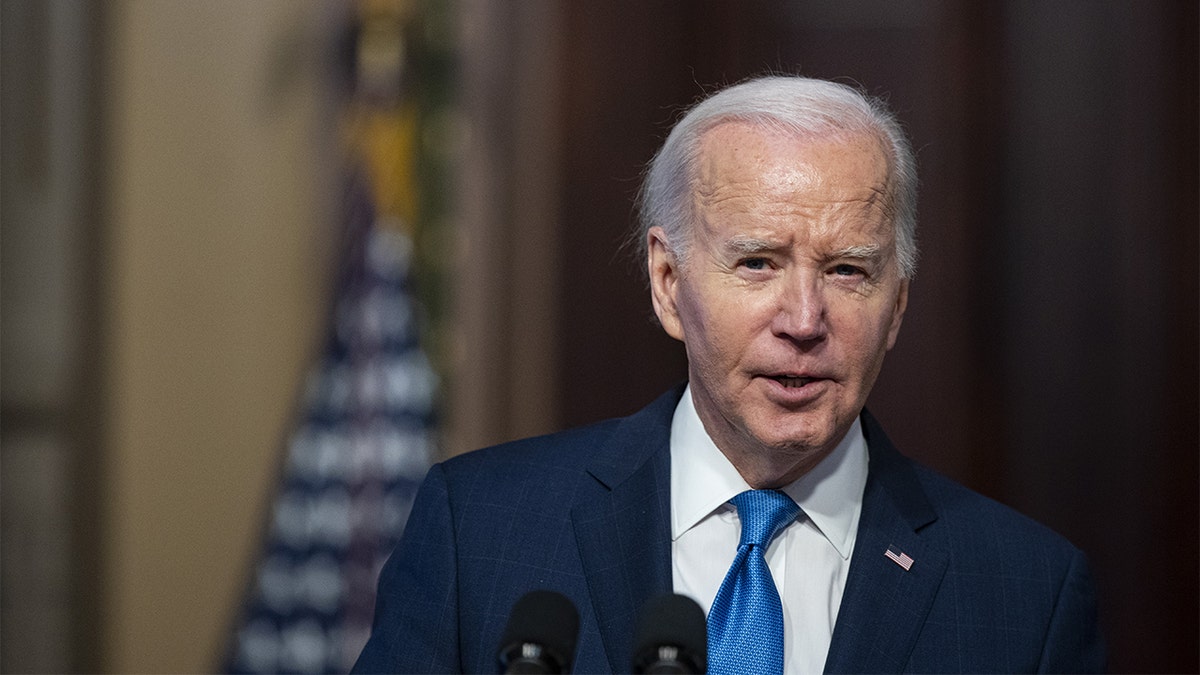 President Joe Biden in blue tie at microphone