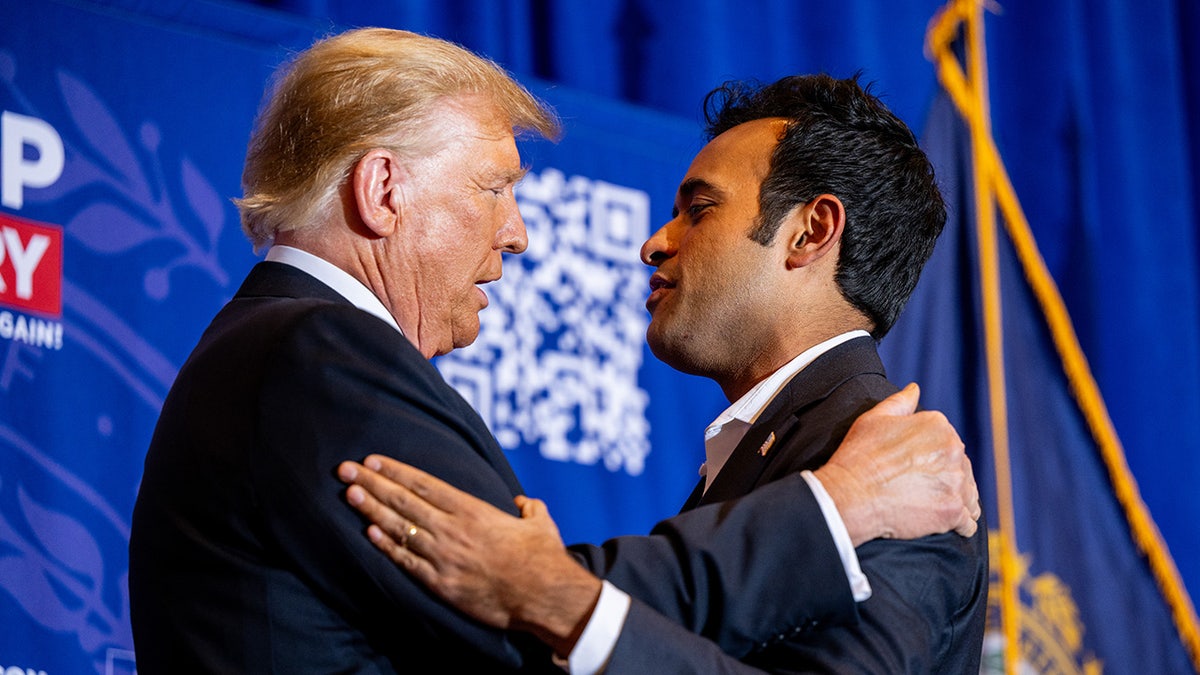 Ramaswamy and Trump embrace on stage