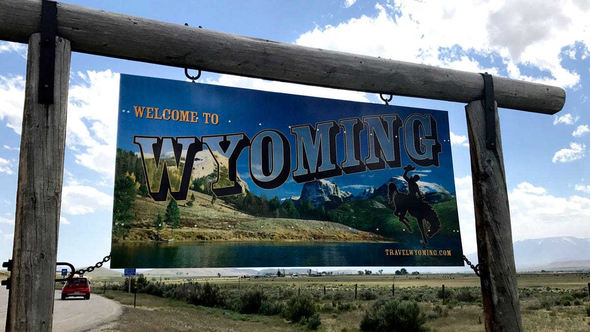 A "Welcome to Wyoming sign" marks the border between Wyoming and Montana