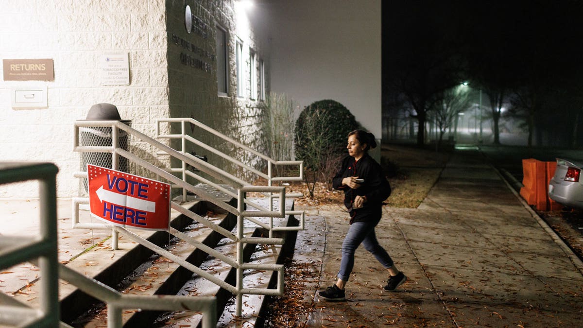 A person walks towards a polling location