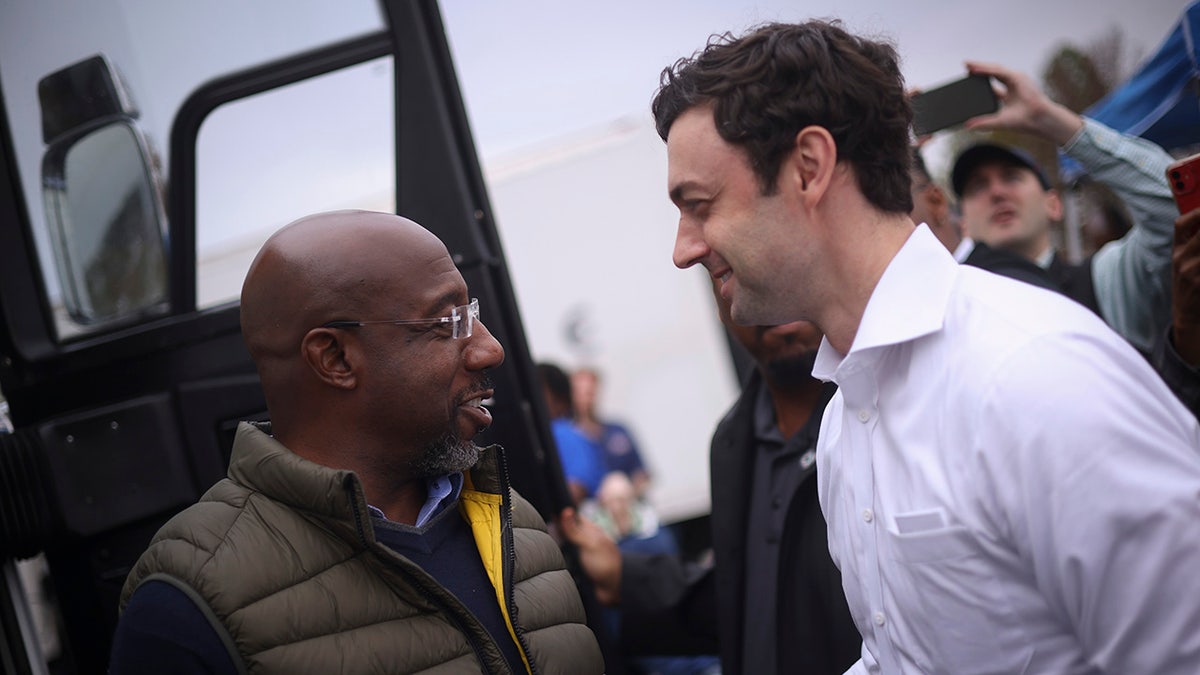 Ossoff and Warnock shake hands