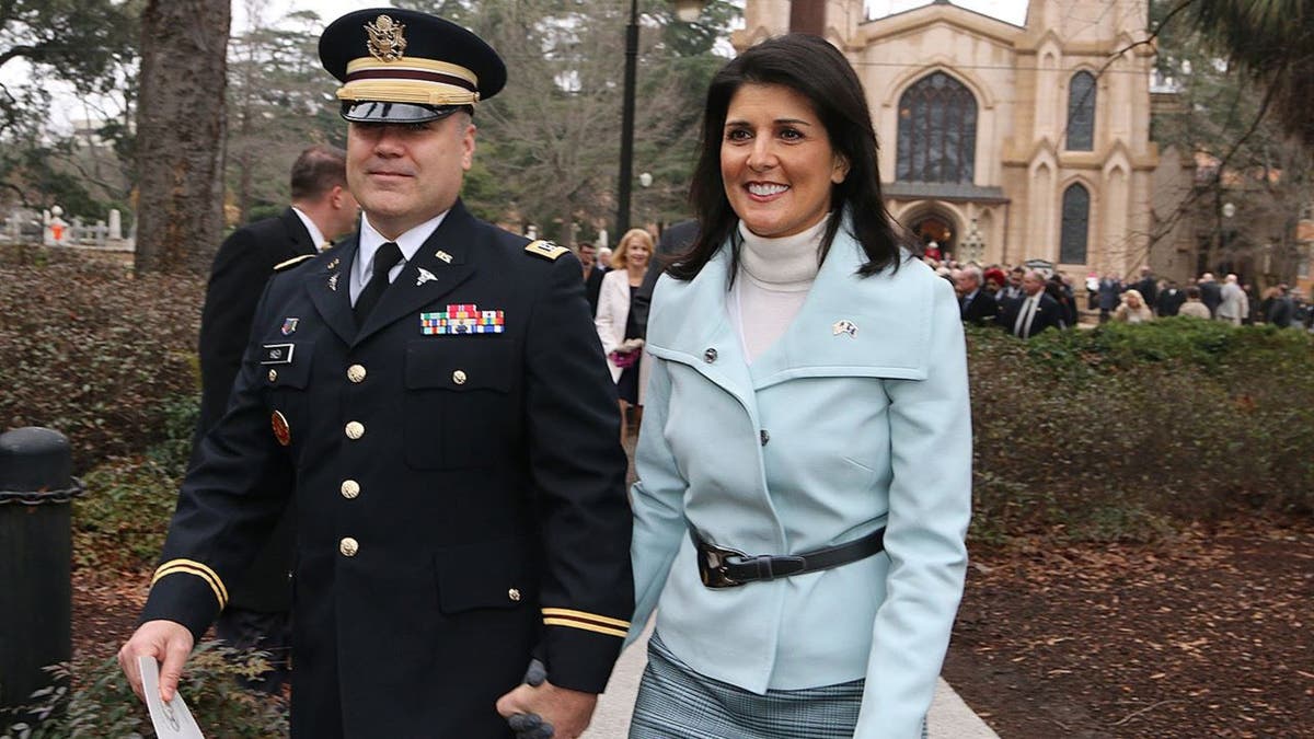 Nikki Haley walking with uniformed husband