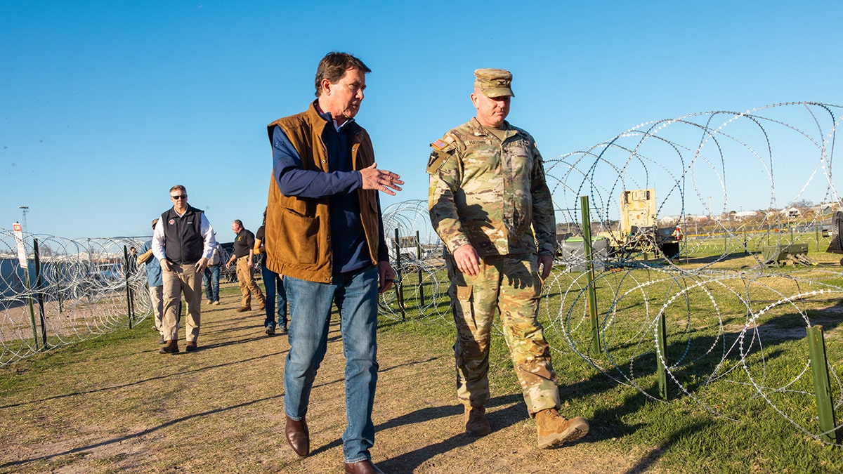 Sen Hagerty walks along concertina wire on border