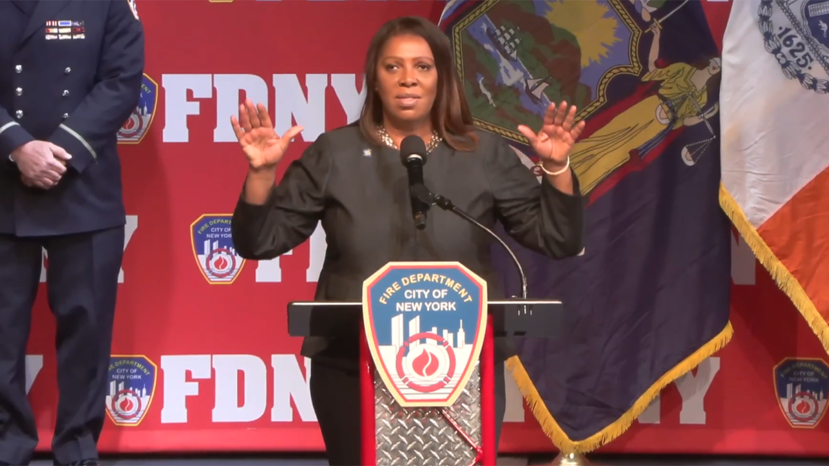 NY AG Letitia James with her arms up