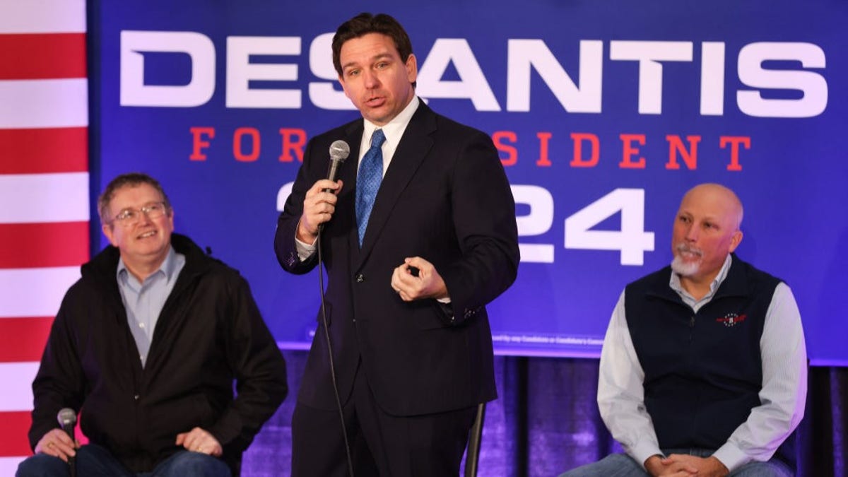 Reps. Thomas Massie and Chip Roy flank Florida Gov. Ron DeSantis as he speaks to the media during his now-defunct 2024 presidential primary bid