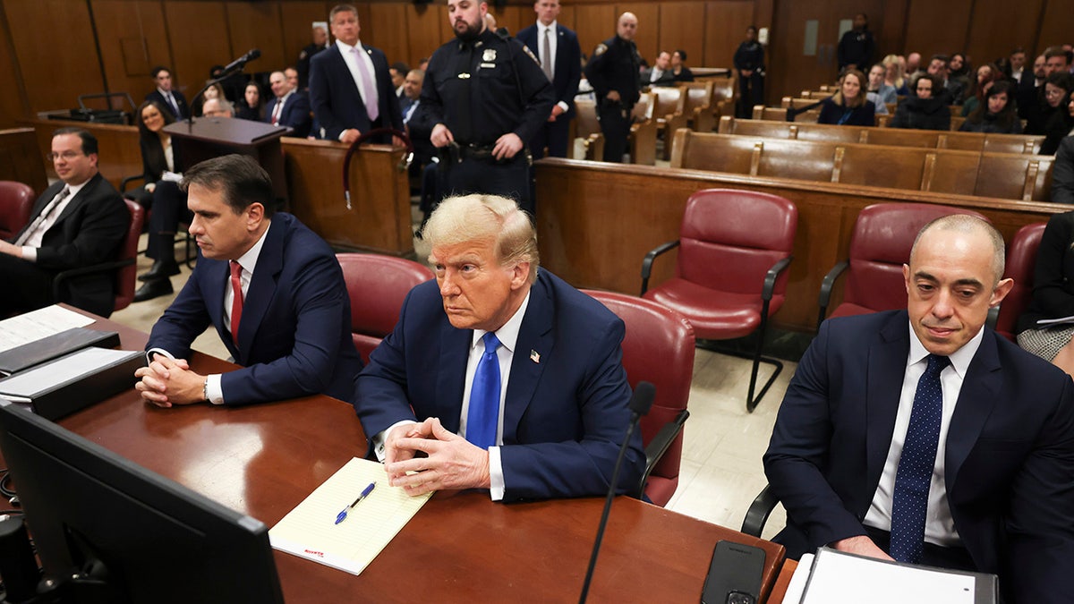 Donald Trump sits in the courtroom for the first day of opening arguments in his Manhattan criminal trial.