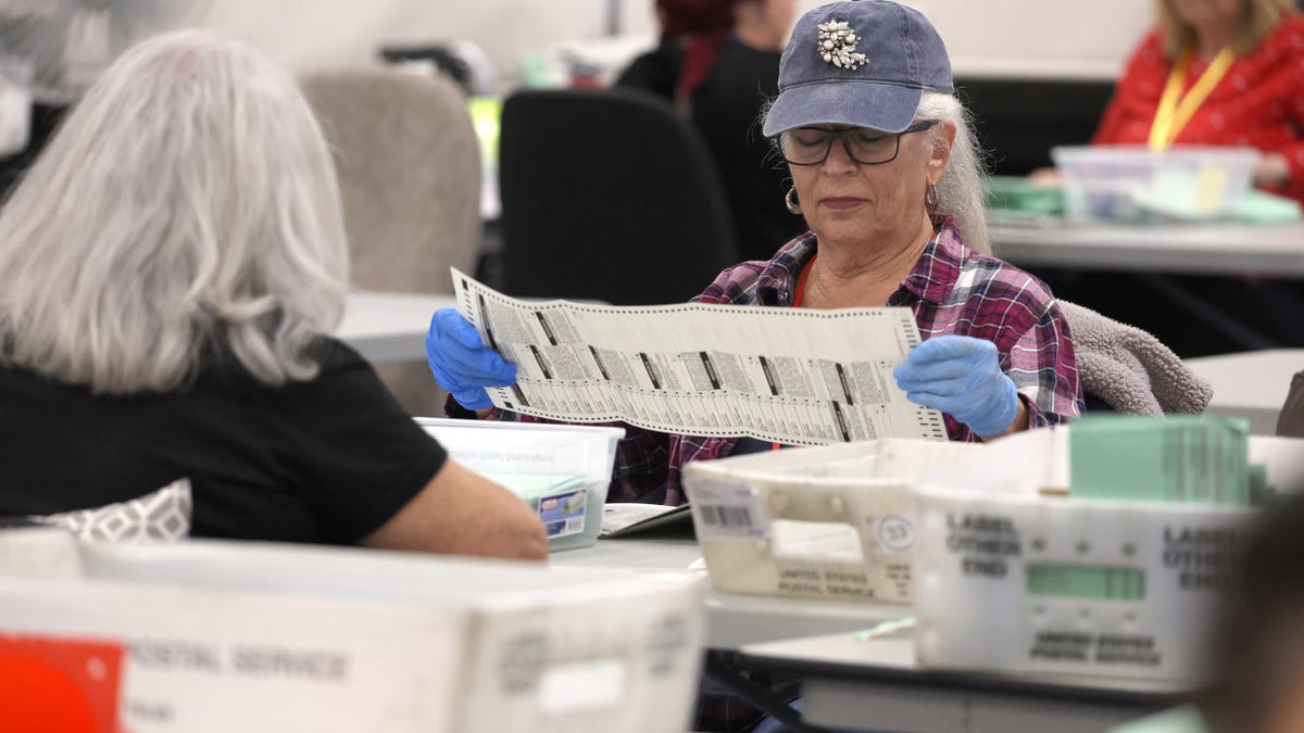 Workers inspect voter ballots
