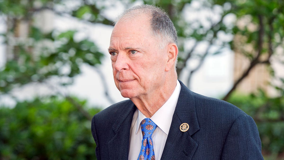 Rep. Bill Posey wears suit and blue tie outside.