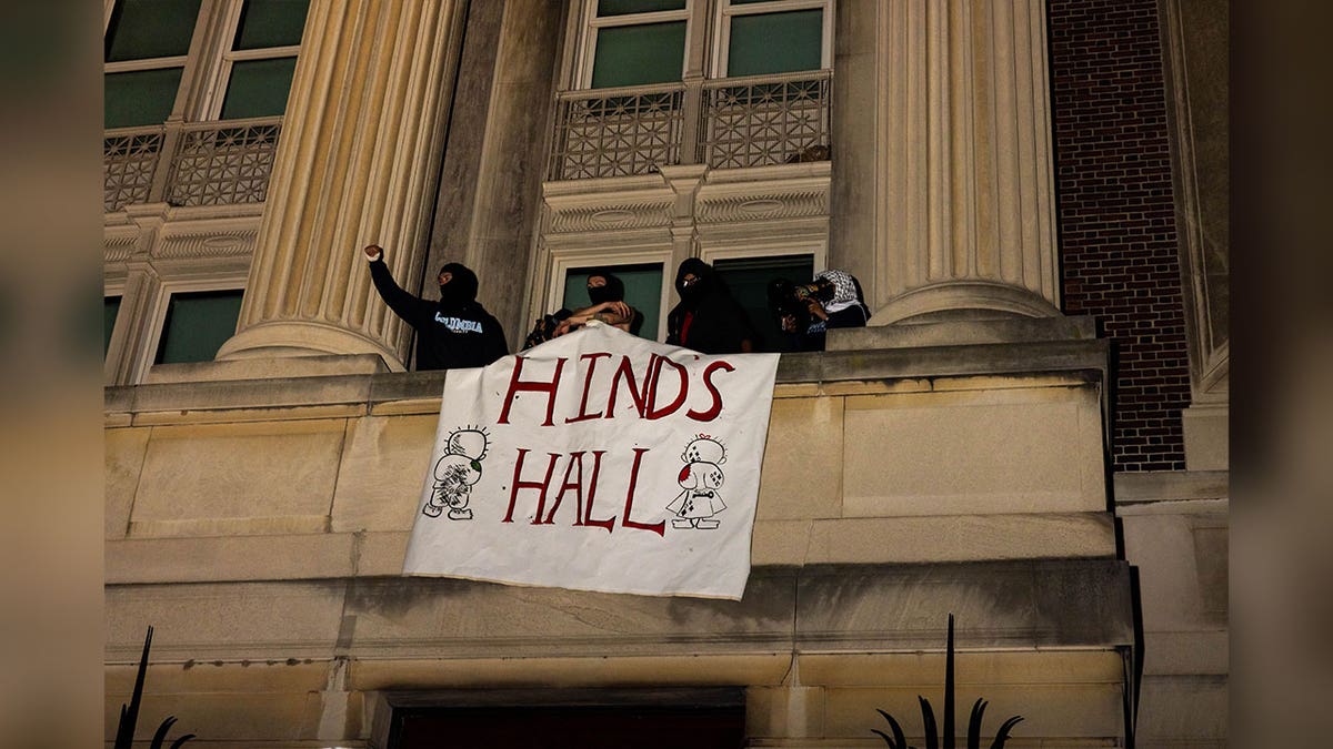 sign displaying "hinds hall" hangs outside building during columbia university takeover