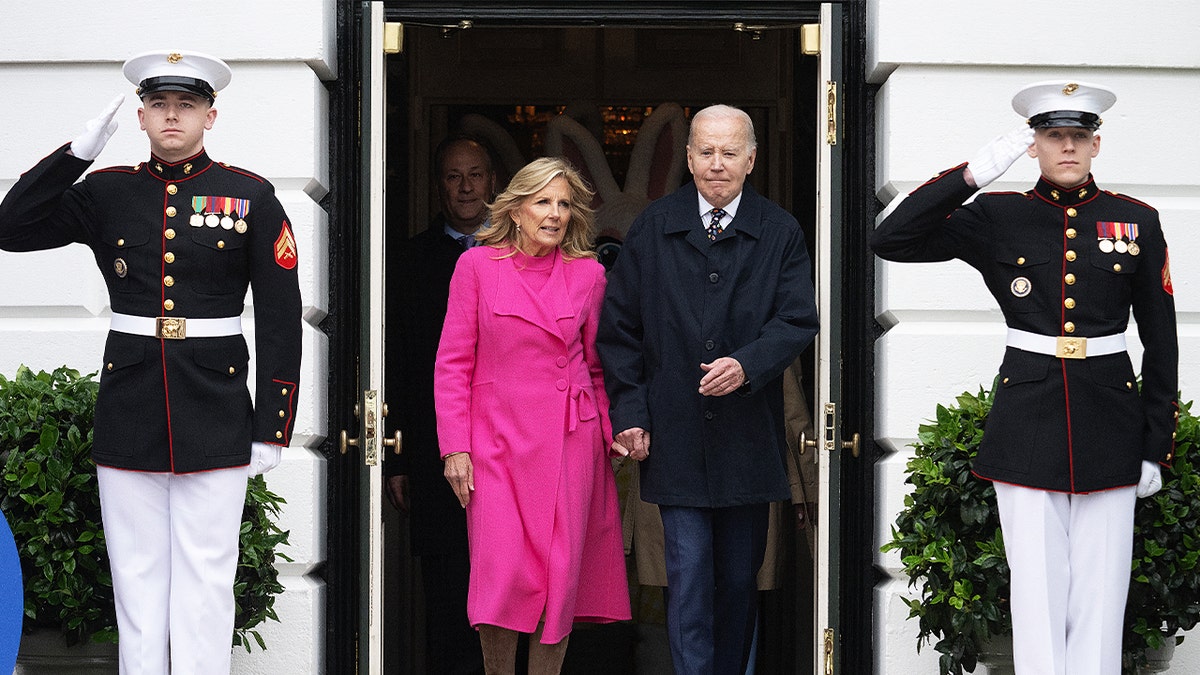 Jill and Joe Biden exiting the White House as Marine guards salute