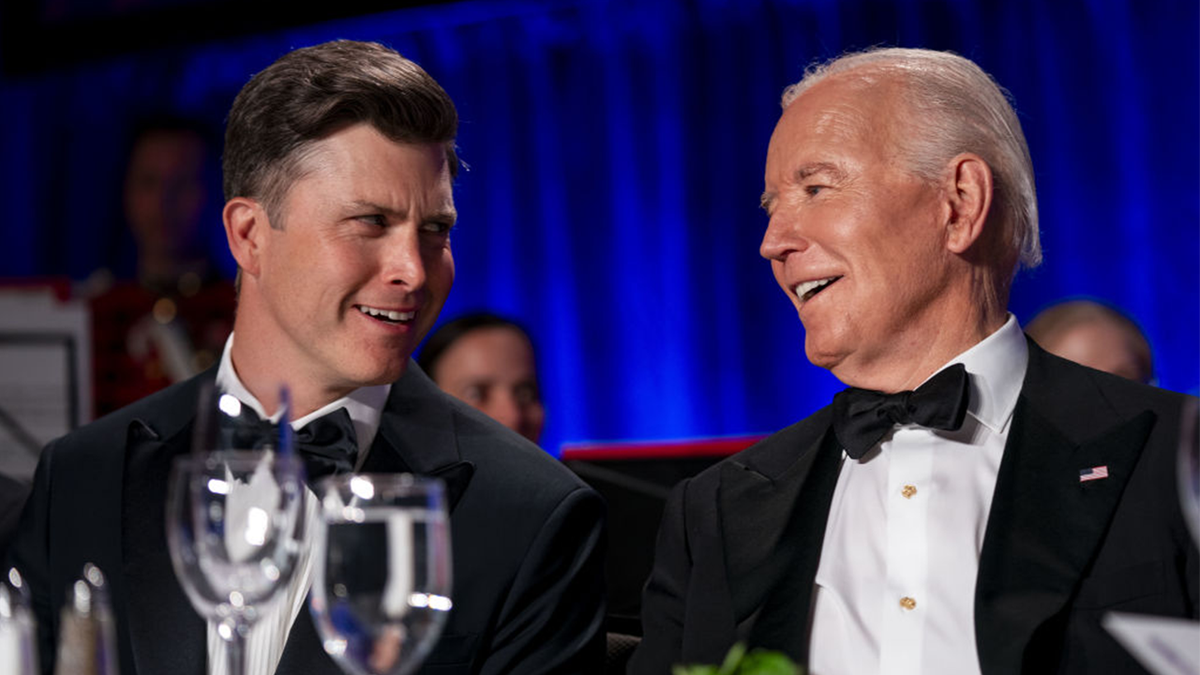 President Joe Biden, right, with comedian Colin Jost, left, on dais at correspondents dinner