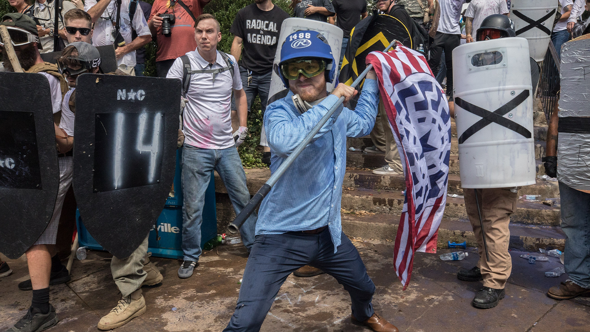 man at Unite the Right rally wields flagpole as weapon