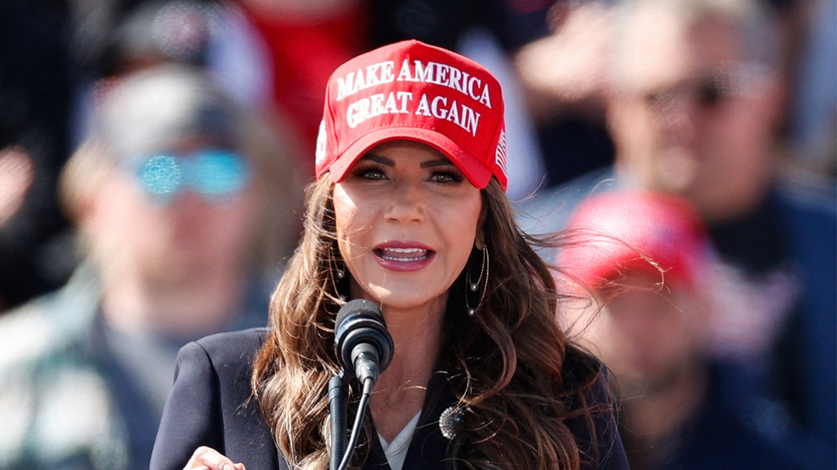 Kristi Noem wearing a red Make America Great Again hat