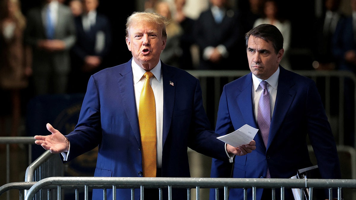 Former U.S. President Donald Trump speaks to the press alongside his lawyer Todd Blanche