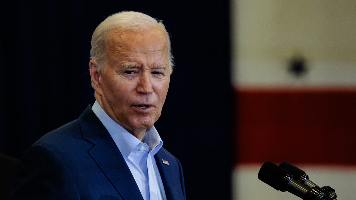 President Biden in light blue shirt, navy jacket