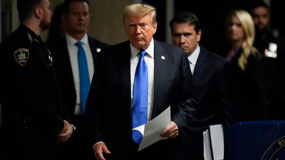 Donald Trump in dark coat and blue tie 