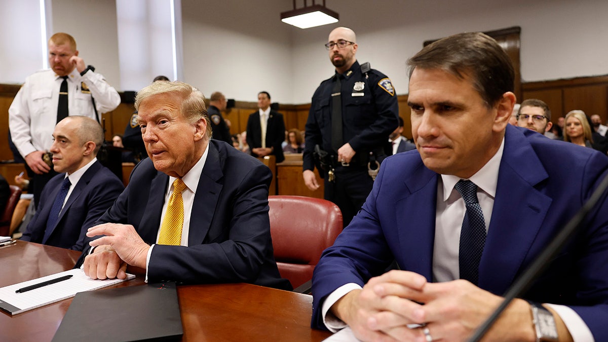 Donald Trump in gold tie in courtroom