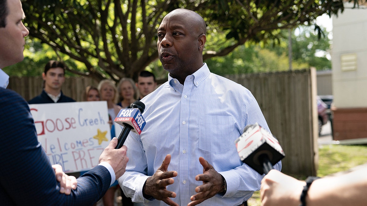 Scott speaking with reporters