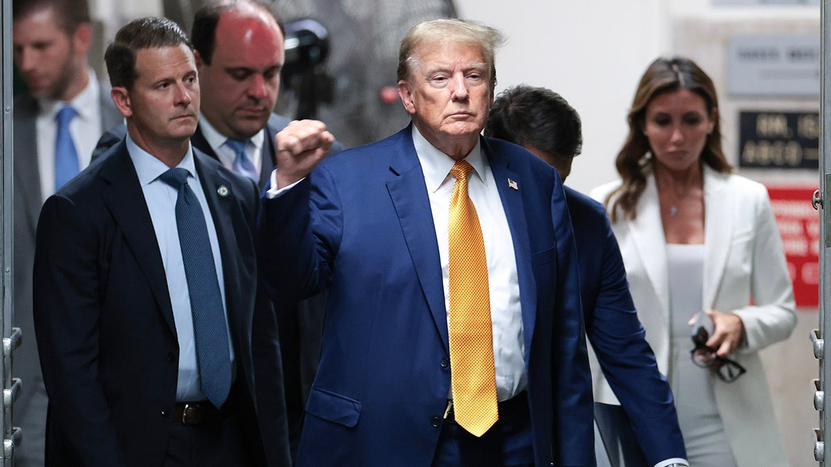 Trump fist pumps in front of Manhattan courthouse