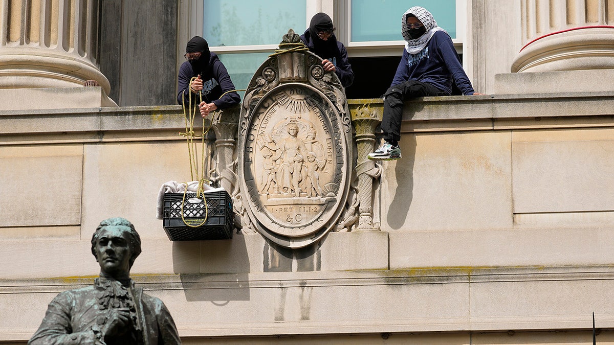 anti-Israel agitators on ledge at Hamilton Hall on Columbia University campus