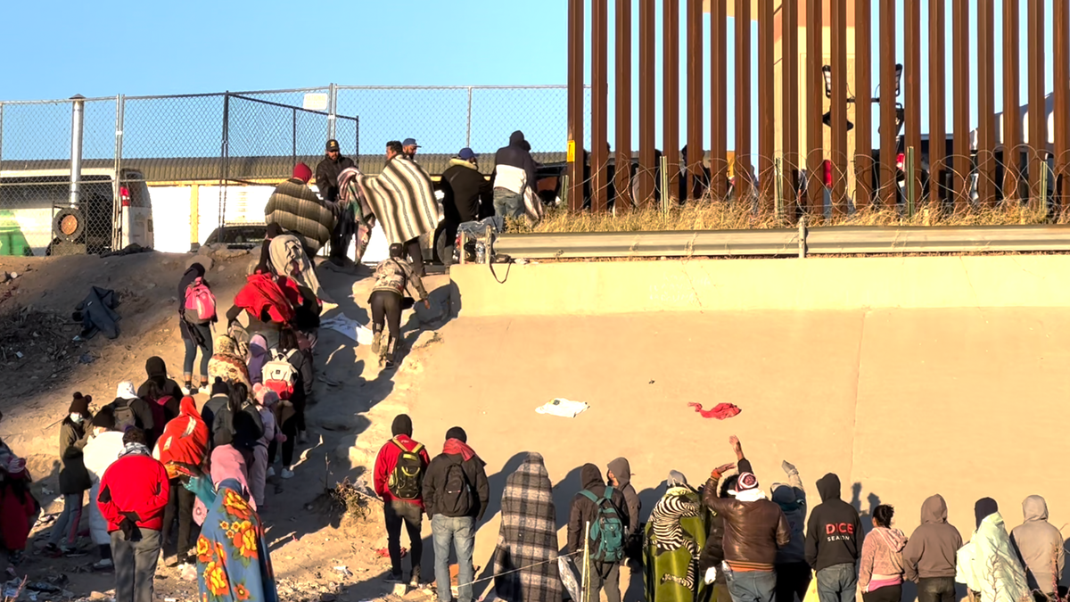 Migrants standing in line at the US southern border