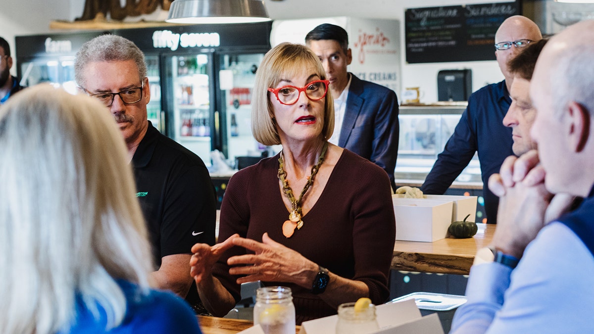 Suzanne Crouch talking with people in diner