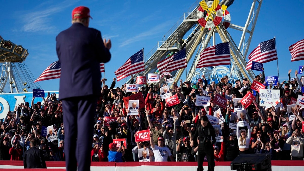 Trump on stage at rally seen from behind