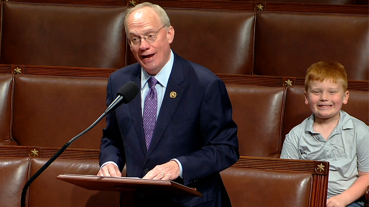 Rep. John Rose's son smiles at the camera.