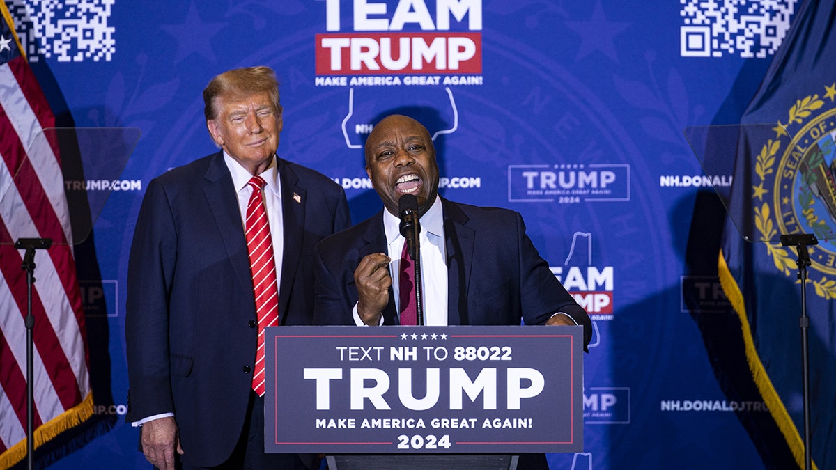 Sen. Tim Scott and Trump at podium