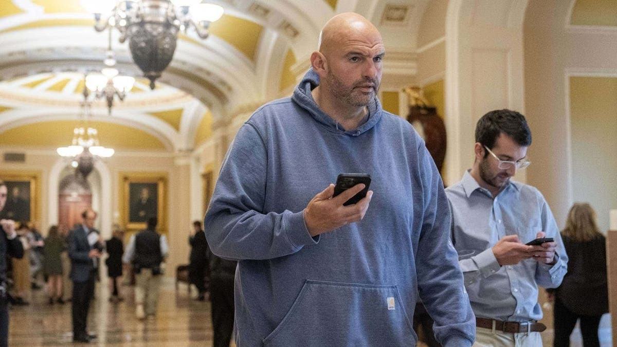 Fetterman walking with phone