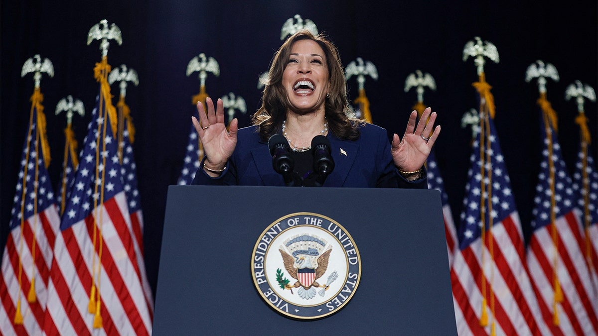 Kamala Harris laughing at lectern