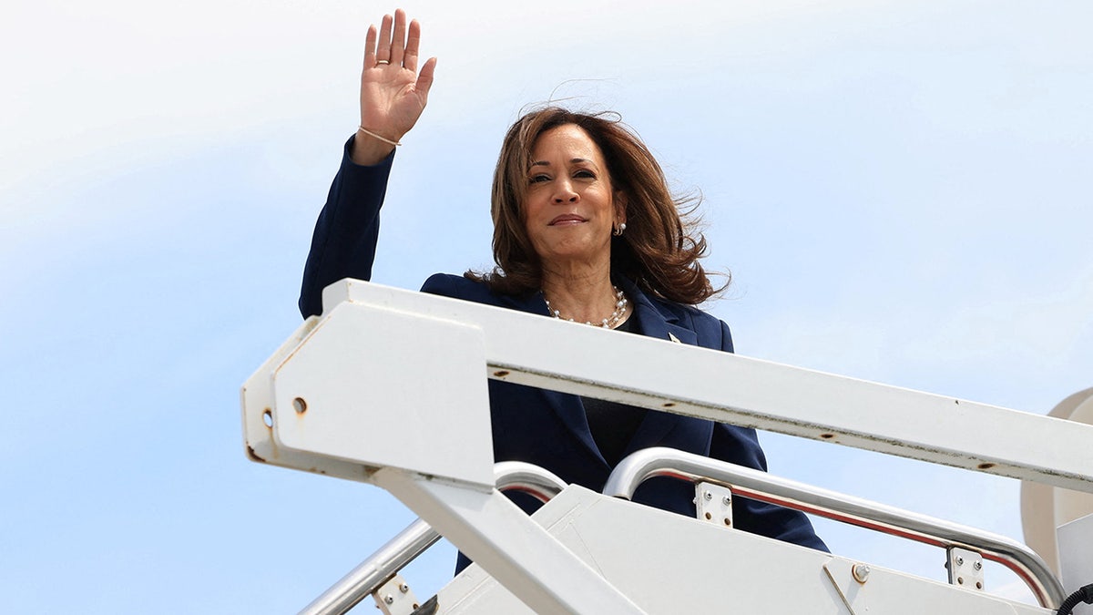 Kamala Harris on steps to Air Force Two, waving