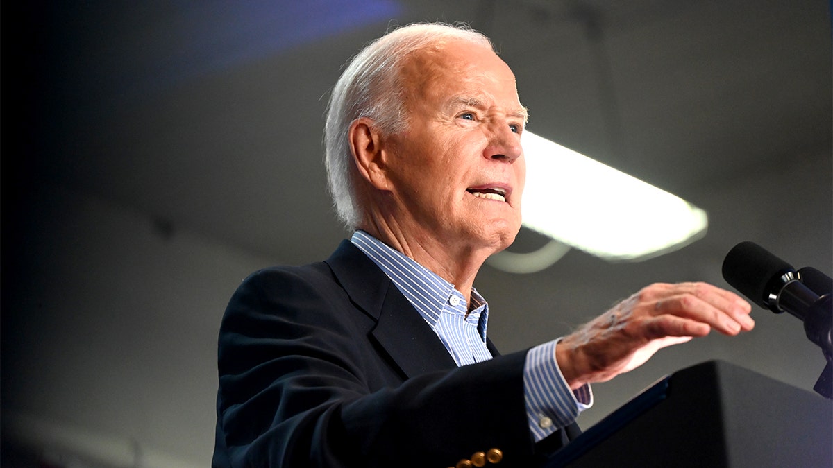 Joe Biden standing at a podium while addressing a crowd.