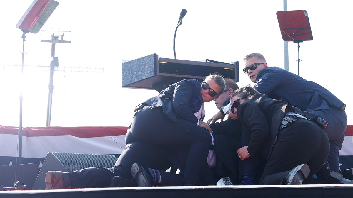 Republican presidential candidate former President Donald Trump is rushed offstage during a rally