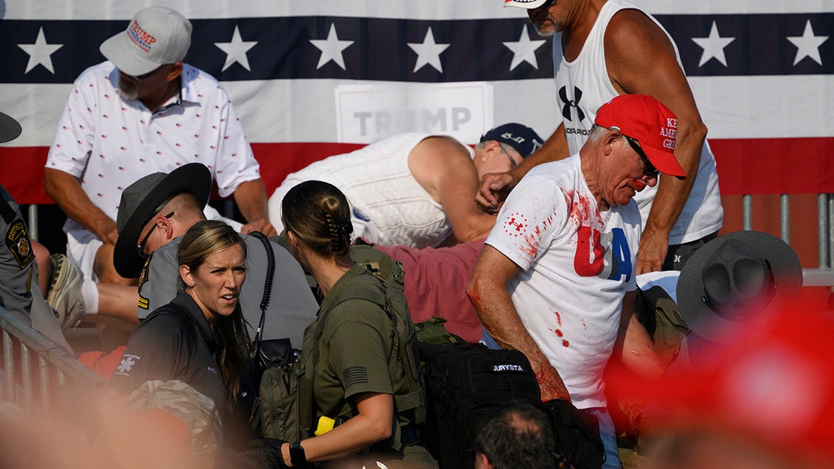 Attendees scatter after gunfire rang out during a campaign rally for Republican presidential candidate, former U.S. President Donald Trump