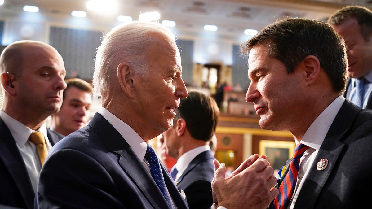 President Biden talks with Rep. Seth Moulton (D-MA), right, after the State of the Union address to a joint session of Congress on Feb. 7, 2023 in the House Chamber of the U.S. Capitol in Washington, D.C.