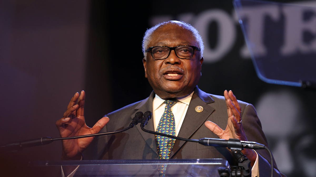 Rep. Jim Clyburn raises hands during speech