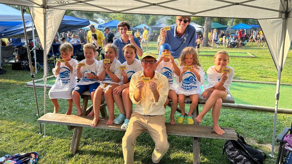 Mike Ramone smiles with children