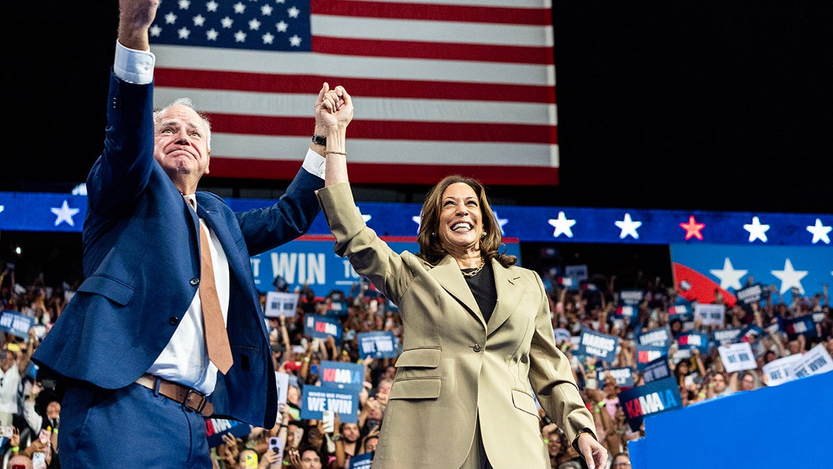 Harris and Walz raise hands