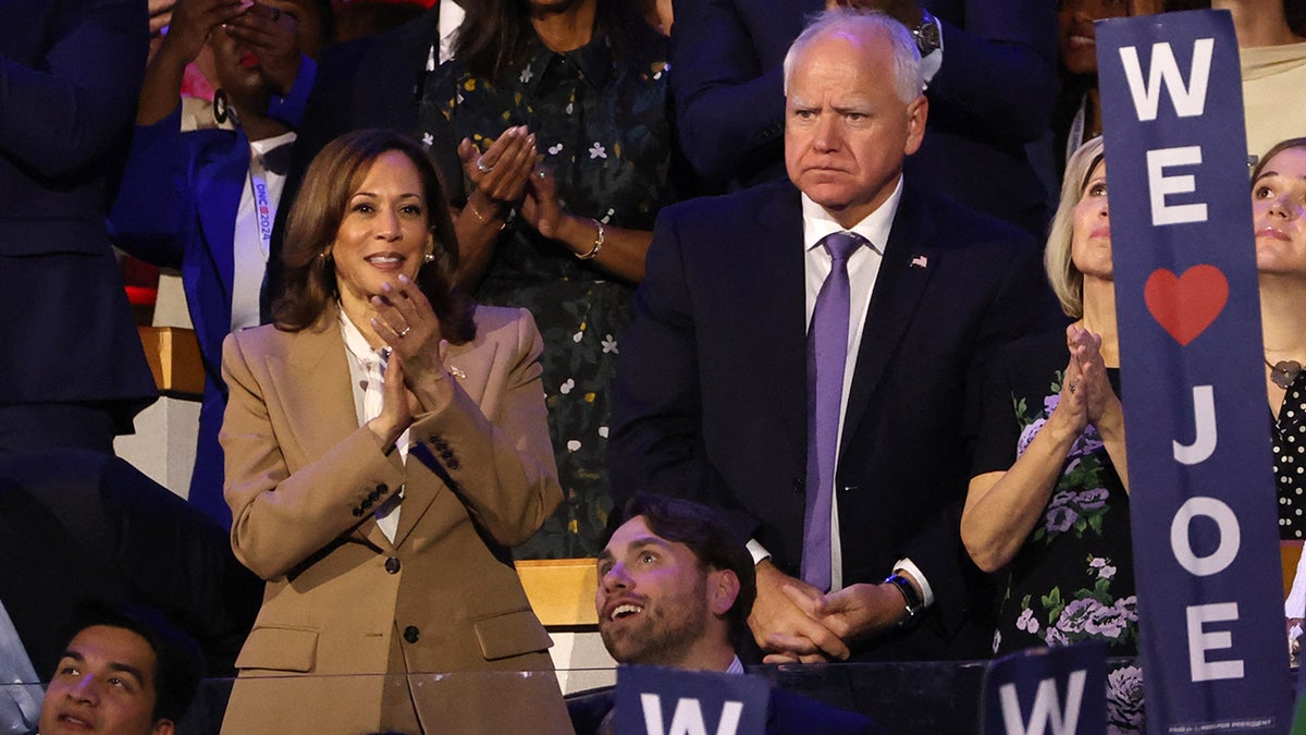 Democratic presidential candidate and U.S. Vice President Kamala Harris and U.S. Democratic vice presidential candidate Minnesota Governor Tim Walz look on