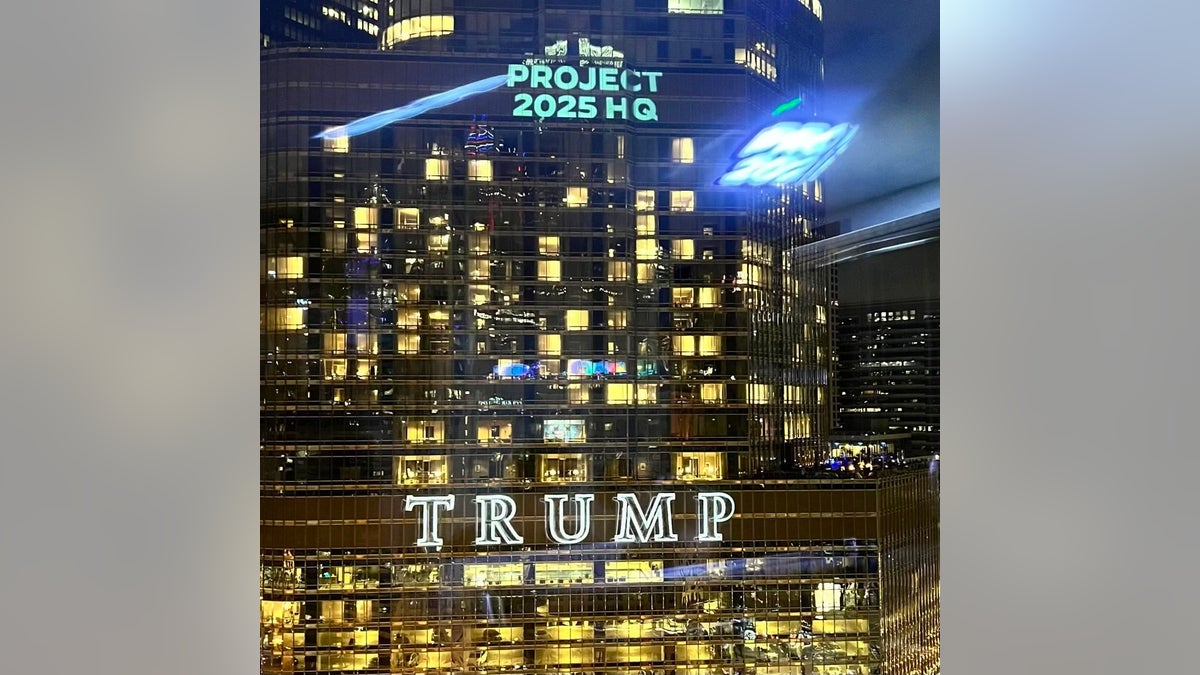 The Democratic National Committee projects images on Trump Tower in Chicago on the eve of the Democrats' national convention on Aug. 18, 2024.