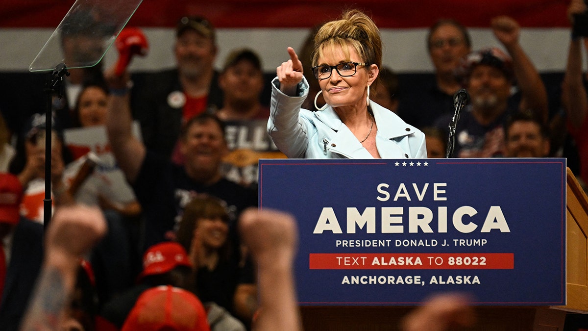 Sarah Palin speaking at an event with former President Donald Trump