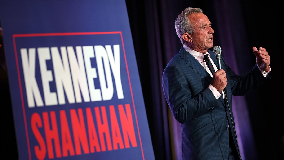 Robert F. Kennedy, Jr. holding microphone at campaign event