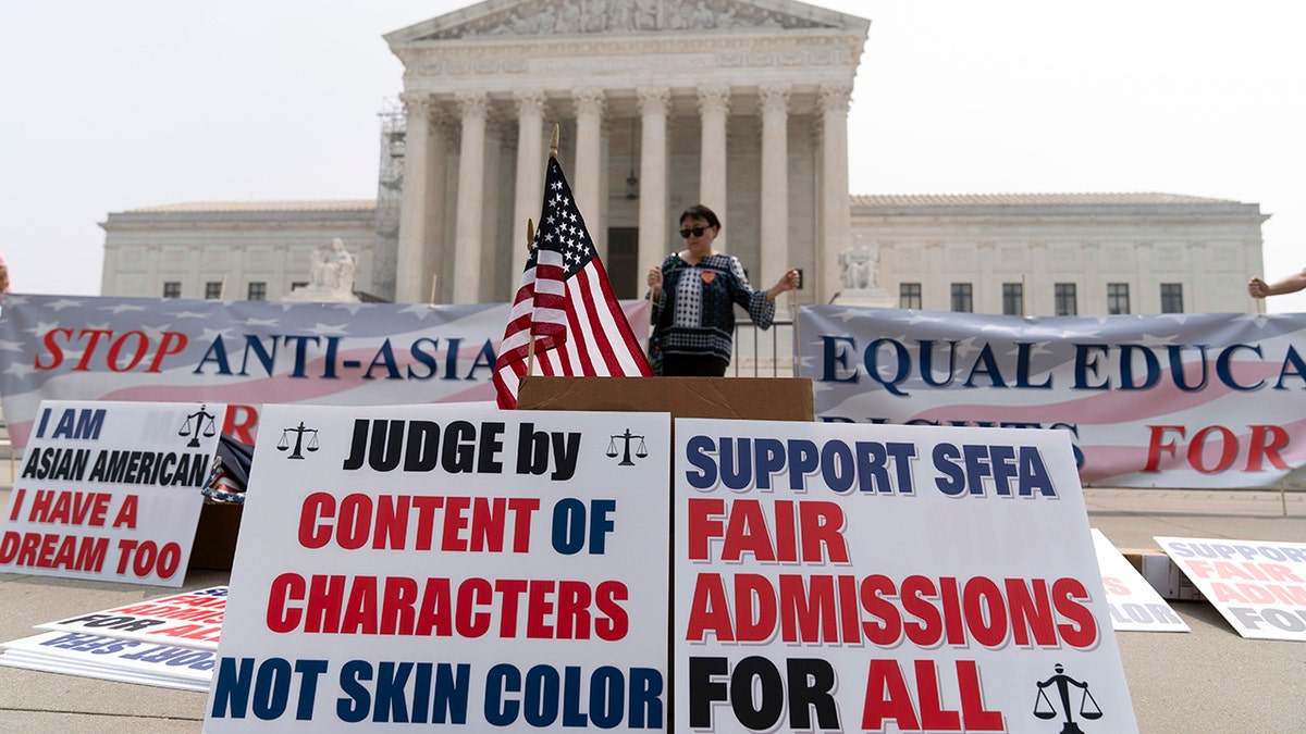 Supreme Court protester with posters