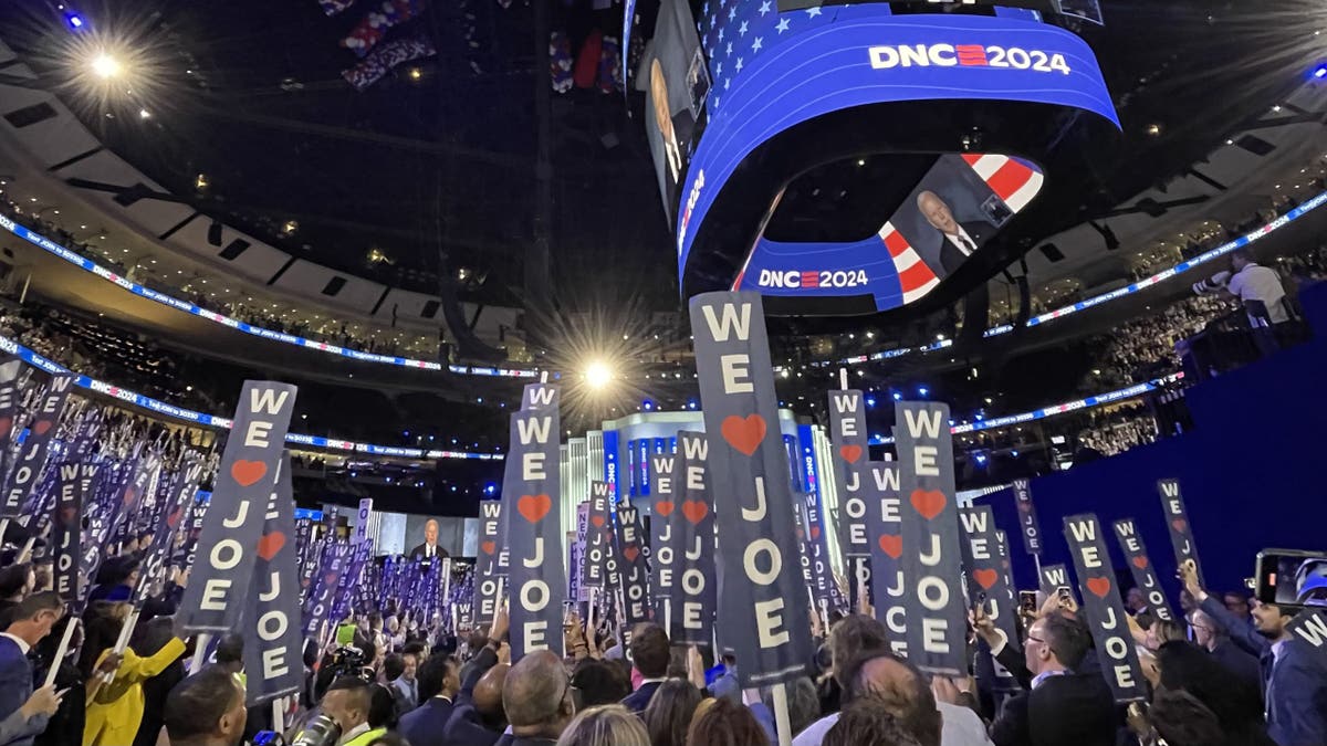 As President Biden speaks at the Democratic National Convention, "We Love Joe" signs fill the United Arena, in Chicago, Illinois on August 19, 2024 