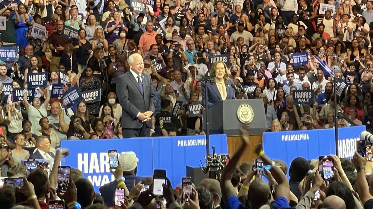 Vice President Kamala Harris (right) and her running mate, Minnesota Gov. Tim Walz, speak in front of a large crowd in Philadelphia, Pennsylvania, on August 6, 2024, as they kick off a battleground state campaign swing 